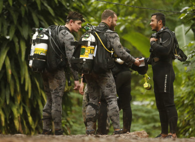 Australian Federal Police and Defence Force personnel talks to Thai rescue before diving.