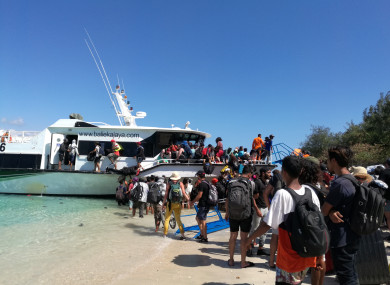 Visitors evacuate from Gili Trawangan near Lombok Island in Central Indonesia