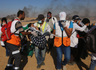 Medical staff carry an injured girl during clashes on Gaza-Israel border, east of the southern Gaza Strip City of Khan Younis.