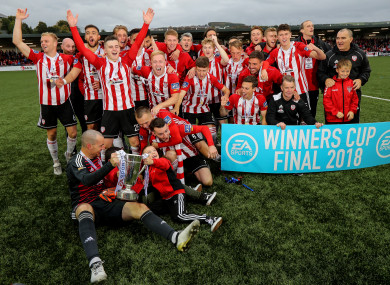 Derry City players celebrate with the trophy.