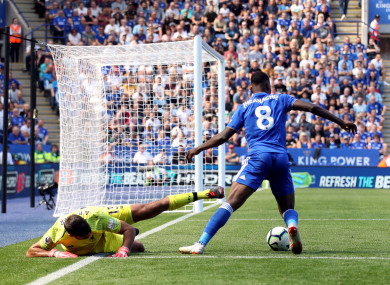 Leicester City's Kelechi Iheanacho wins the ball off Liverpool goalkeeper Alisson.