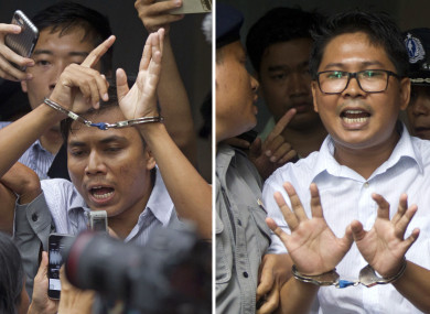 Reuters journalists Kyaw Soe Oo, left, and Wa Lone, are handcuffed as they are escorted by police out of the court today.