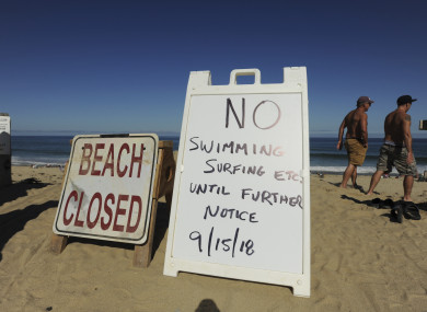 Two signs at the top of the dune at Newcomb Hollow Beach.