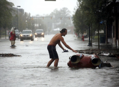A local in New Bern, North Carolina checks a statue that was toppled by Hurricane Florence