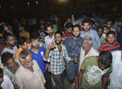 A crowd gathering at the site of the train accident.