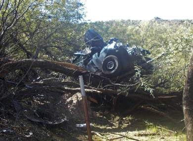 The woman's car stuck in the mesquite tree.