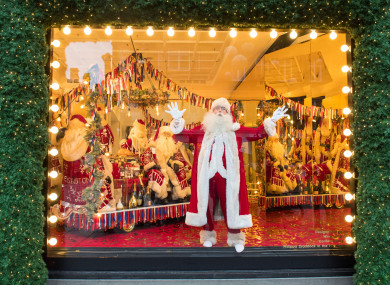 Santa Claus inside in Christmas window in Selfridges in London.