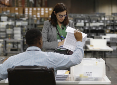 Employees at the Palm Beach County Supervisor of Elections office sort ballot pages during a recount