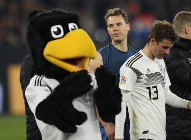 The Germany forward (right) exits the field dejected.