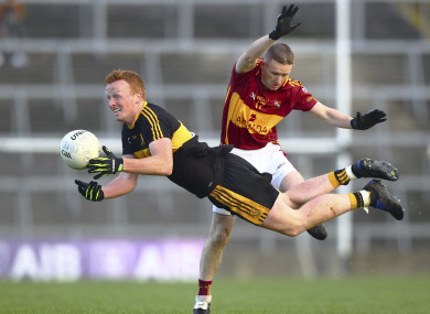 Dr Crokes Johnny Buckley tackled by Miltown-Malbay's Eoin Curtin.