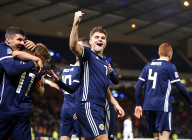 Scotland's James Forrest (centre) celebrates scoring his side's third goal of the game.
