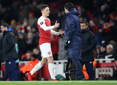 Mesut Ozil shakes hands with manager Unai Emery after being substituted during Arsenal's Europa League win over Qarabag.