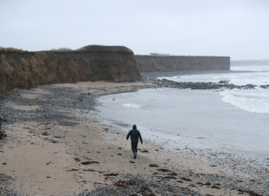 A man walks along a beach in Balbriggan, north of Dublin, near the scene where the body of a newborn baby was found.