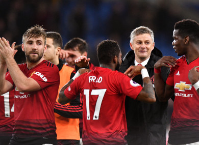 The interim manager celebrates with the United players.