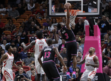 Miami Heat guard Dwyane Wade scores against the Houston Rockets.