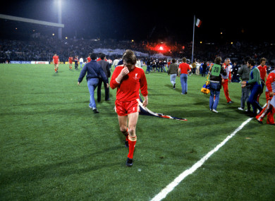 Liverpool's Kenny Dalglish walks off the pitch after his team's 1-0 defeat.