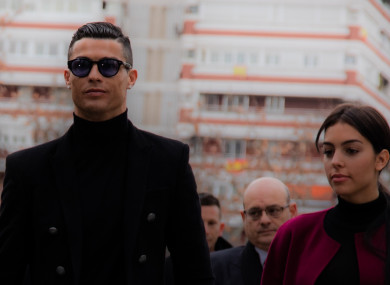 Portuguese soccer player Cristiano Ronaldo arrives at the provincial court of Madrid with his girlfriend Georgina Rodriguez for his tax evasion trial.