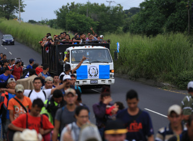 Honduran migrants ride in a truck in a caravan heading to the United States through Guatemala and Mexico