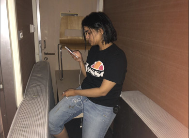 Photo released by Rahaf Mohammed Alqunun/Human Rights Watch, Rahaf Mohammed Alqunan views her mobile phone as she sits barricaded in a hotel room at an international airport in Bangkok, Thailand.