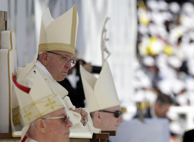 Pope Francis sits in front of the altar as he celebrates a mass at the Sheikh Zayed Sports City Stadium in Abu Dhabi.