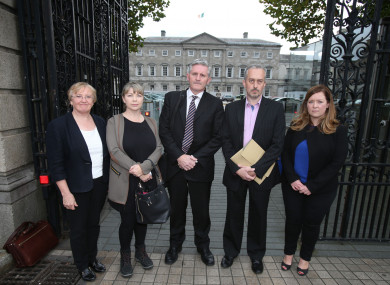 A group of tracker mortgage scandal victims, with financial adviser Padraic Kissane (centre) after a hearing in Leinster House.