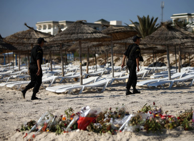 Police officers patrol the beach in Sousse, Tunisia, where 38 people lost their lives after a gunman stormed the beach.
