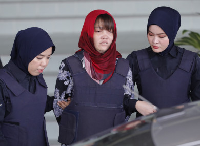 Police escort Doan Thi Huong from court