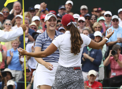 Kupcho gets a hug from Maria Fassi after sinking her birdie putt on the 18th green.