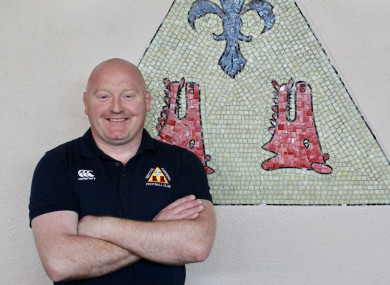 Bernard Jackman poses in front of the Bective club crest.