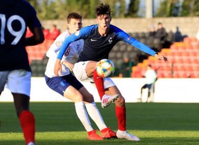 Theo Zidane of France in possession, with England's Jensen Weir paying close attention.