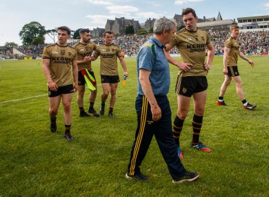 Peter Keane and David Moran leave the field after beating Mayo.