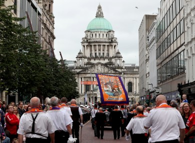 Bandsmen and Orange Order members take part in an Orange Order parade in Belfast