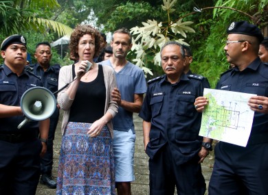 Meabh Quoirin - the mother of a missing girl Nora Quoirin speaks to police officers as Nóra's father Sebastien Quoirin, centre, stands beside her.
