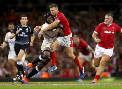 Maro Itoje and Wales's Dan Biggar battle for the ball.