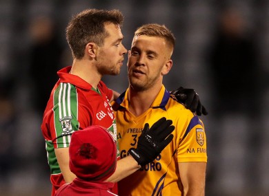 Dean Rock shakes hands with Jonny Cooper of Na Fianna after the game.