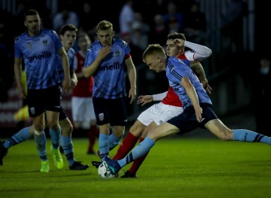 St Pat's Glen McAuley with Harry McEvoy of UCD.