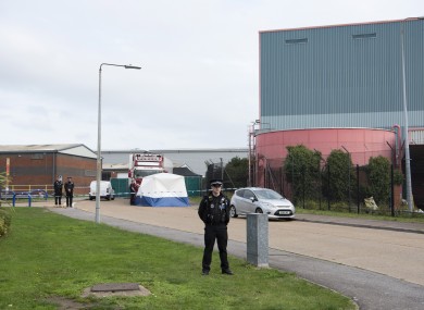 Police officers at the scene where 39 bodies were found in a shipping container in Essex.