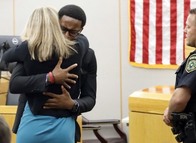 Brandt Jean hugs Amber Guyger at her sentencing hearing.