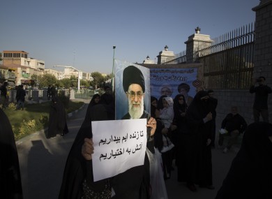 Iranian hardliners attend a protest against the Government's permission to female fans for entering the soccer stadiums in front of the Iranian Parliament building in downtown Tehran.