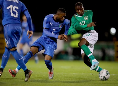 Ireland's Michael Obafemi with Claud Adjapong of Italy.