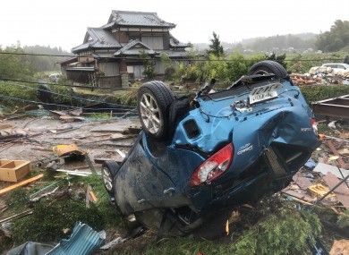 A car is overturned after a tornado hit Chiba Prefecture near Tokyo.