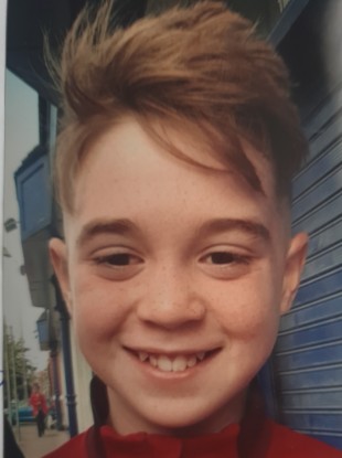 The 11-year-old boy was found with multiple injuries at a house on Sunday night.