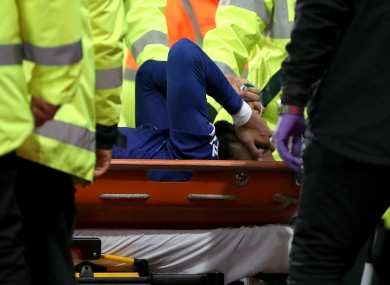 Everton's Andre Gomes is carried off the field by medical staff.