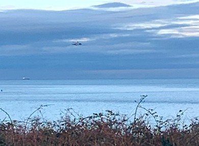 A helicopter and lifeboats are searching for the missing aircraft and its pilot.