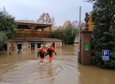 Rescue workers in a flooded street in southern France yesterday.