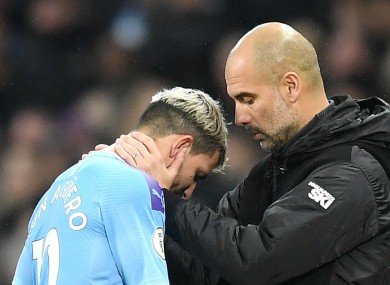 Manchester City striker Sergio Aguero is consoled by Pep Guardiola