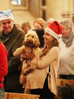 Caroline Price with her dog Penny during the annual Peata therapy dog carol service at Christ Church Cathedral in Dublin.