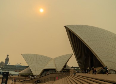 The sky over the Opera House covered by heavy red smoke from bushfire.