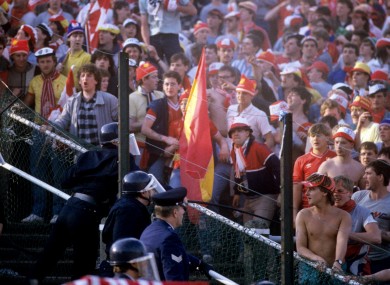 Liverpool fans pictured with the police inside Heysel Stadium.
