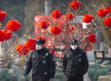 Officials wearing face masks among decorations for the Chinese New Year.